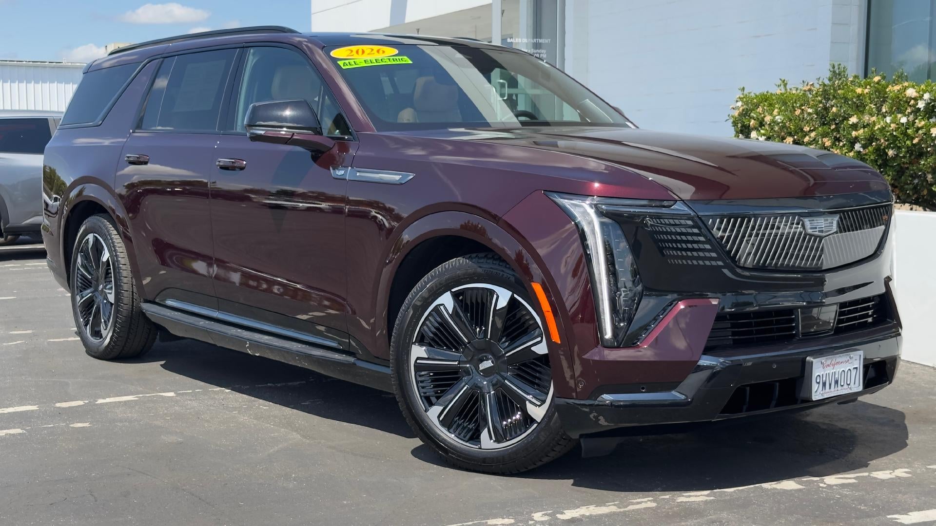 2026 Cadillac ESCALADE IQL Premium Sport in Black Cherry Tintcoat — front three-quarter view